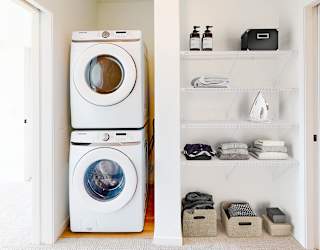 a white washer and dryer in a white laundry room