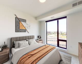 a bedroom with a large bed and a large window