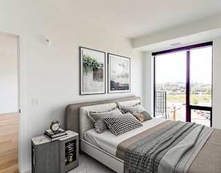 a bedroom with a bed and a large window