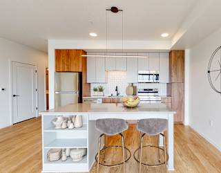 a kitchen with a island and three stools