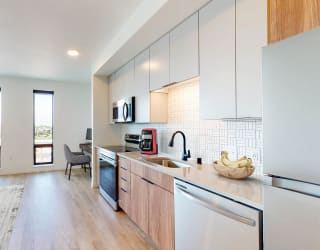 an open kitchen and living room with a view of the city