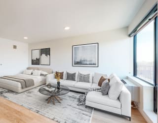 a living room with two couches and a glass coffee table