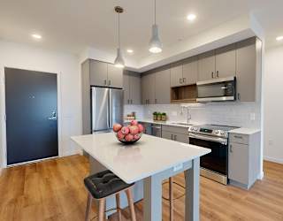 A modern kitchen with a dining table and chairs.