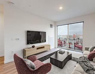 A living room with a red chair and a television.