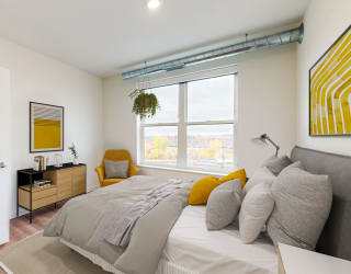 a bedroom with a large bed and a large window