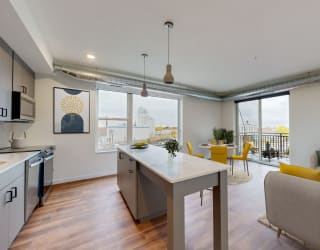 a living room with a kitchen and a dining room