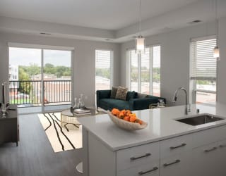 Joel 1 bedroom, kitchen bar for seating and living room areaat Urban Park I and II Apartments, St Louis Park, MN, 55426