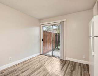 A room with a sliding glass door leading to a backyard.