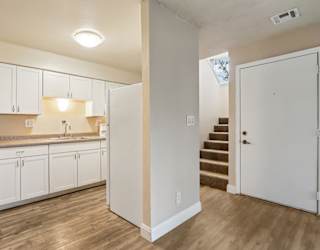 A kitchen with white cabinets and a countertop.