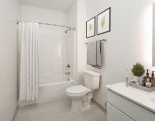 a white bathroom with a shower and a toilet at The Waterford At Rocketts Landing Apartments, PRG Real Estate, Richmond, Virginia