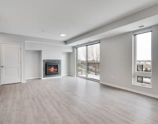 Spacious living and dining area with luxury electric fireplace and a lot of natural light at Aspire at CityPlace in Woodbury, Minnesota