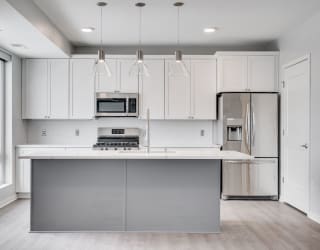 Beautiful kitchen with light luxury finishes, matching stainless steel appliances, and granite countertops