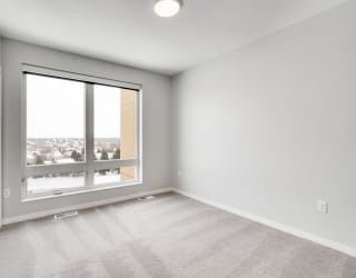 Spacious bedroom with large window and natural light at Aspire at CityPlace in Woodbury, Minnesota