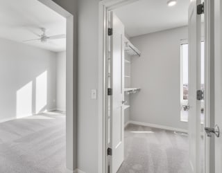 Master bedroom and large master closet with a lot of storage space at Aspire at CityPlace in Woodbury, Minnesota