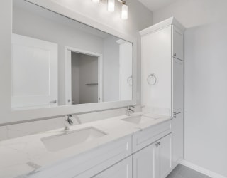 Large dual sink vanity in luxury bathroom at Aspire at CityPlace in Woodbury, Minnesota