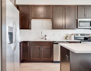 1 bedroom luxury apartment kitchen with dark brown cabinets in Woodbury MN 55125