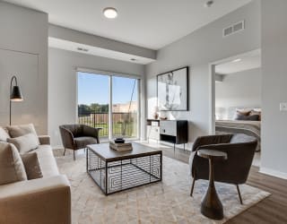 Living space with warm brown floors in luxury apartment Woodbury MN 55125