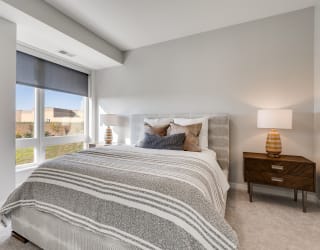 Large bedroom with floor to ceiling window in luxury apartment in Woodbury MN 55125