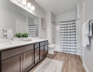 Spacious bathroom with dual vanities and lots of storage in luxury apartment in Woodbury MN 55125