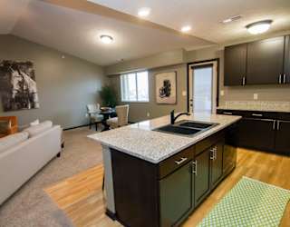 A kitchen with a white sofa and a countertop.