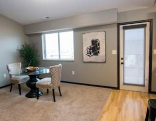 A dining room with a table and chairs.
