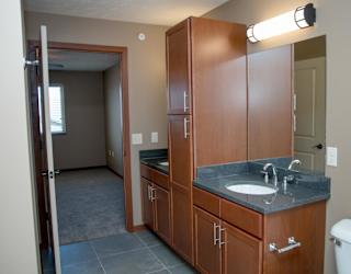 A bathroom with a sink, toilet, and medicine cabinet.
