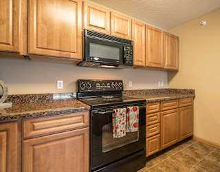 a kitchen with a stove and a microwave