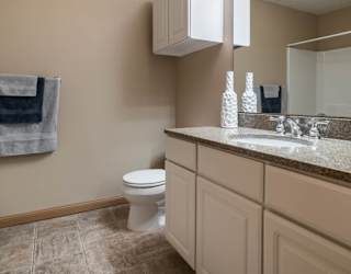 a bathroom with a toilet and a sink and a mirror
