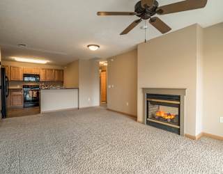 a living room with a fireplace  and a kitchen
