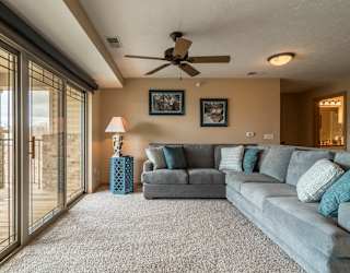 a living room with a couch and a ceiling fan