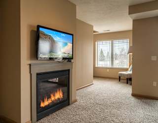 a living room with a fireplace and a tv