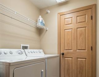 a washer and dryer in a laundry room with a door