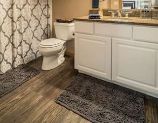 a bathroom with a toilet and a sink and a mirror