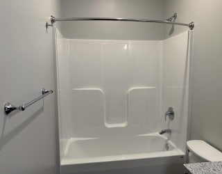 White tub/shower insert with mounted curtain rod