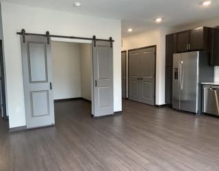 Den or office space with elegant double barn doors at Haven at Uptown
