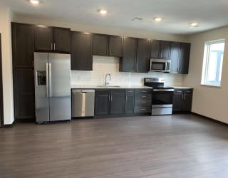 Open kitchen into living and dining area at Haven at Uptown