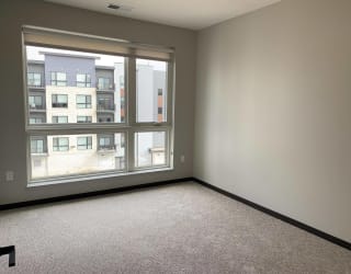 Spacious bedroom with large windows and a lot of natural light in the peace floorplan at Haven at Uptown