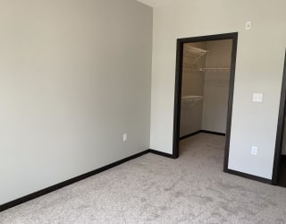 bedroom features spacious walk-in closet with shelving at Haven at Uptown
