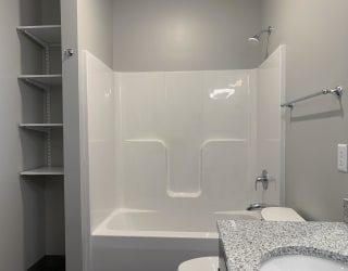 Shower and tub combo with linen storage close by