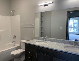 Spacious bathroom with double vanity and shower tub combo