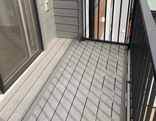 Spacious deck with a view sliding door and screen door entry