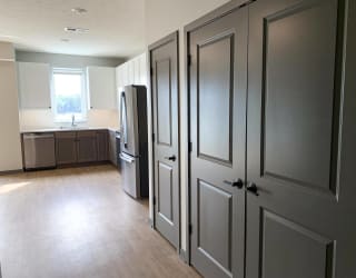 Open kitchen next to spacious storage and laundry closet