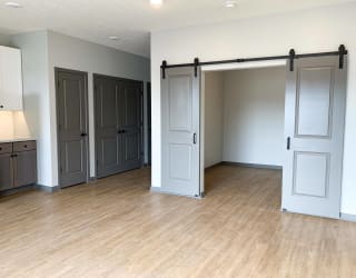 Den or office with gray sliding barn doors