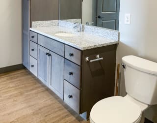 Bathroom features vanity and large cabinet for storage