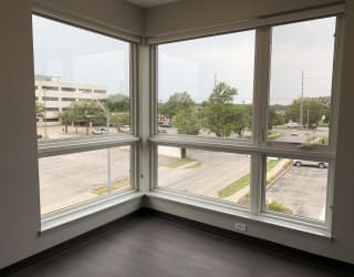 Living room view through corner floor to ceiling windows that look out onto north Lincoln, Nebraska