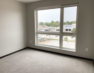 Empty bedroom in a two bedroom apartment with a view outside to north Lincoln, Nebraska