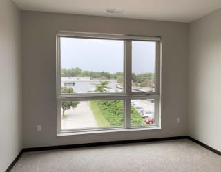 Empty bedroom in a two bedroom apartment with a view outside to north Lincoln, Nebraska
