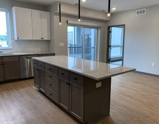 Floating kitchen island with ample counter space at haven at uptown in lincoln nebraska