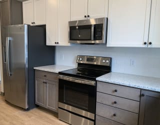 Kitchen with matching stainless steel appliances and white cabinets at haven at uptown in lincoln nebraska