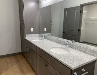 Full bath with double vanity and large mirror at haven at uptown in lincoln nebraska